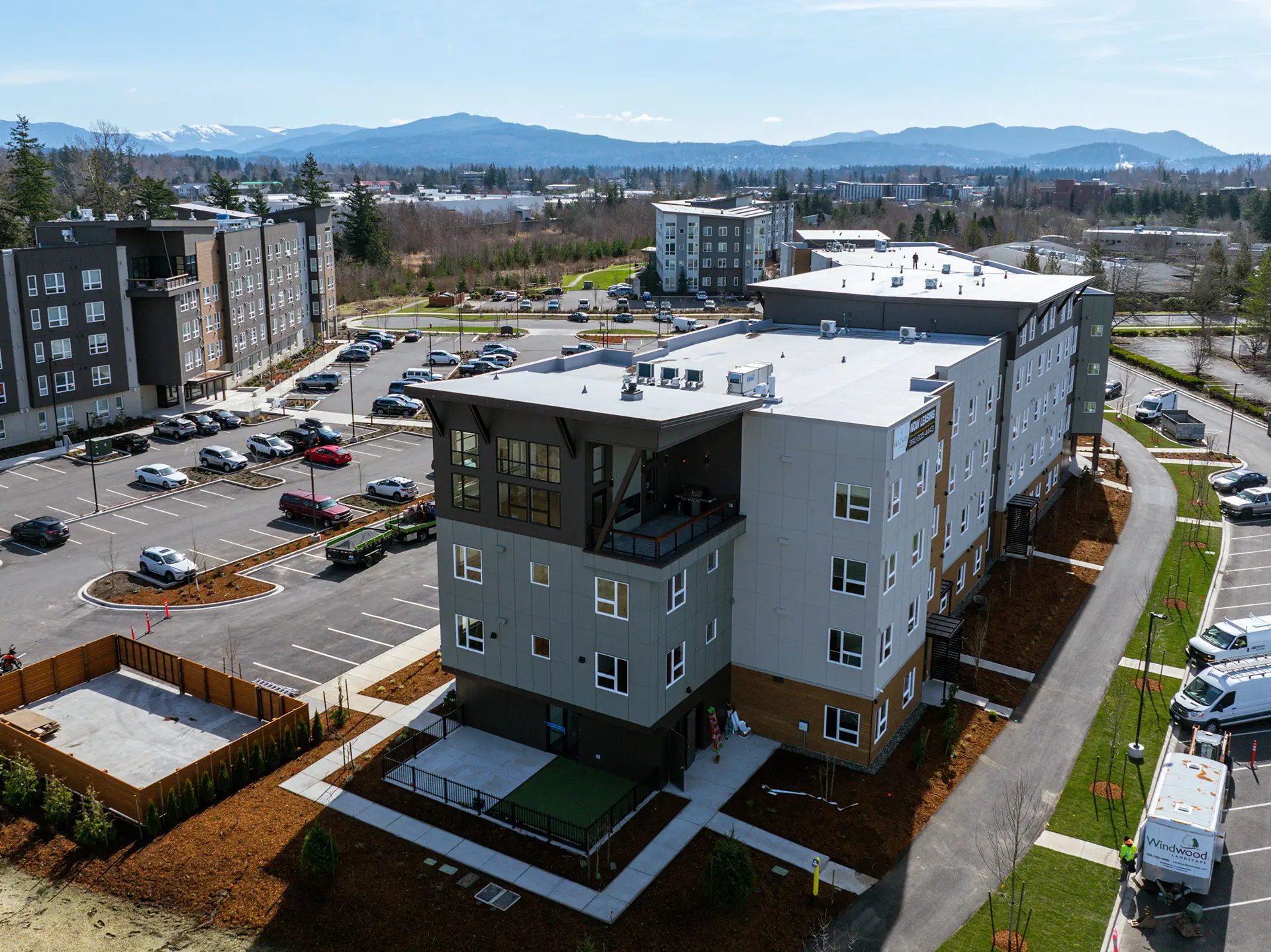 Birds eye view of the end of the Celestia at Cordata apartment building with mountains in the background.