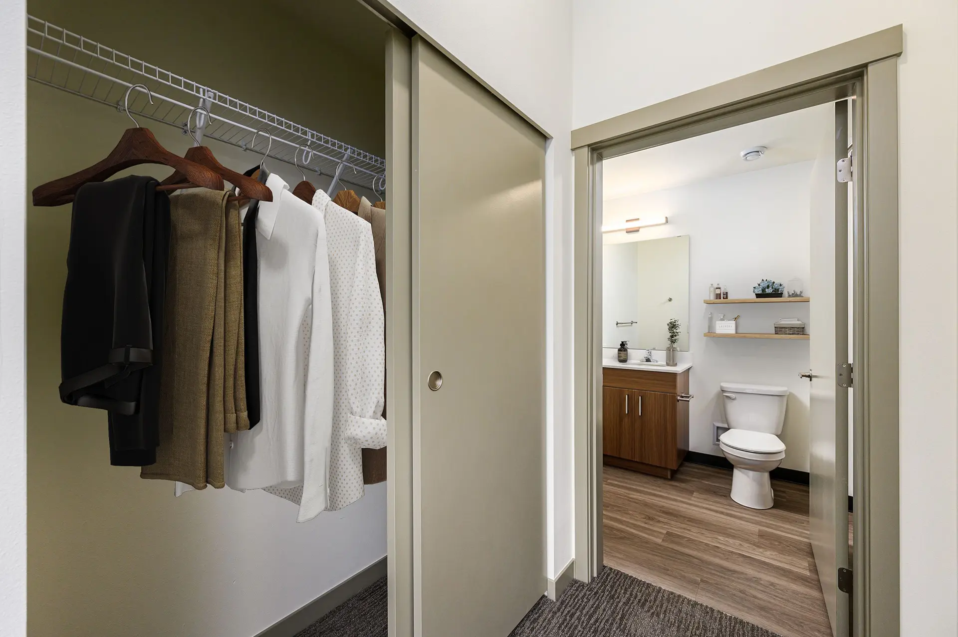 corner view in a bedroom with the sliding door closet on the left and en suite bathroom on the right